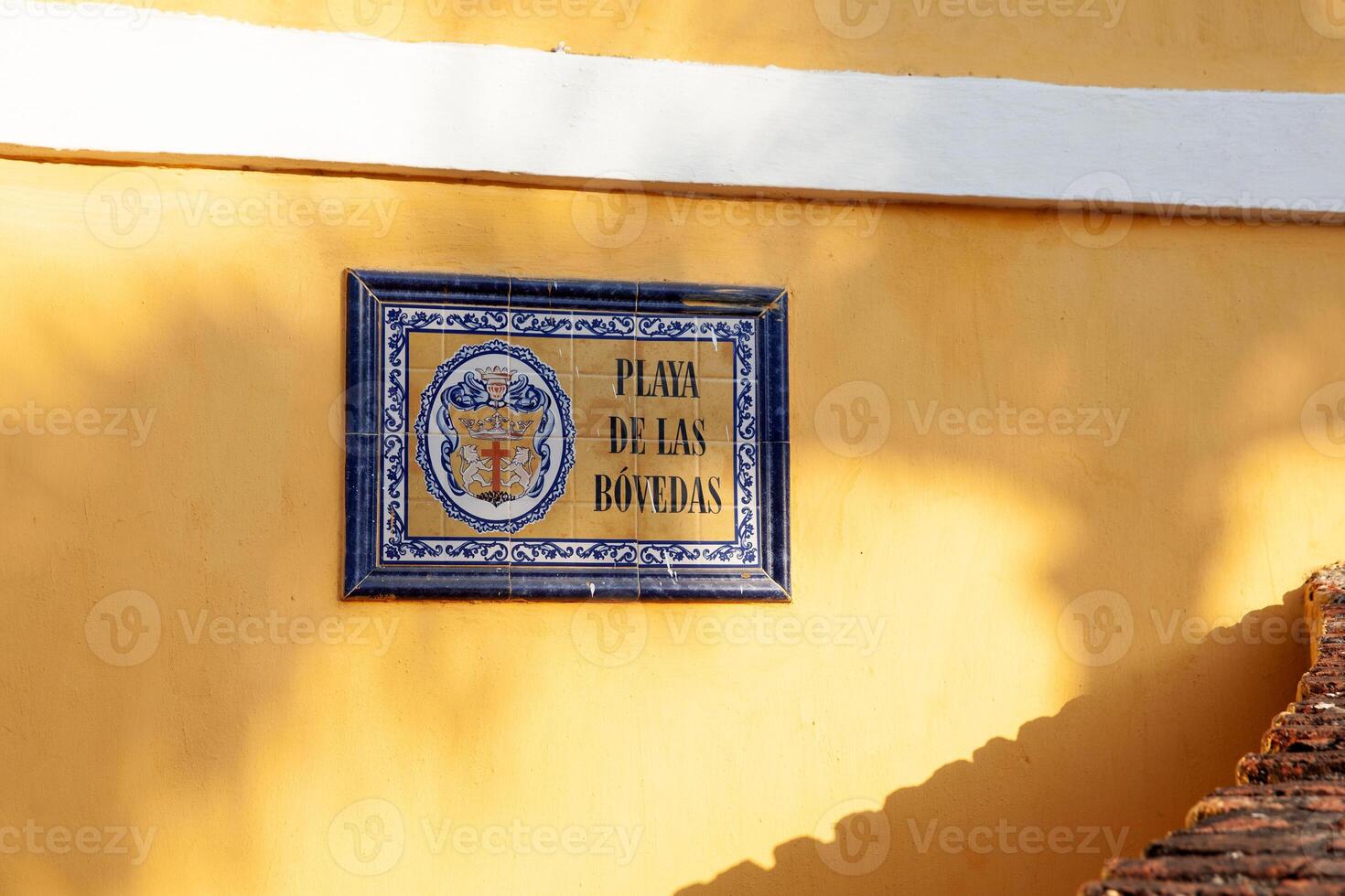 Street sign of the Colonial building of Las Bovedas in the walled city of Cartagena de Indias, Colombia photo