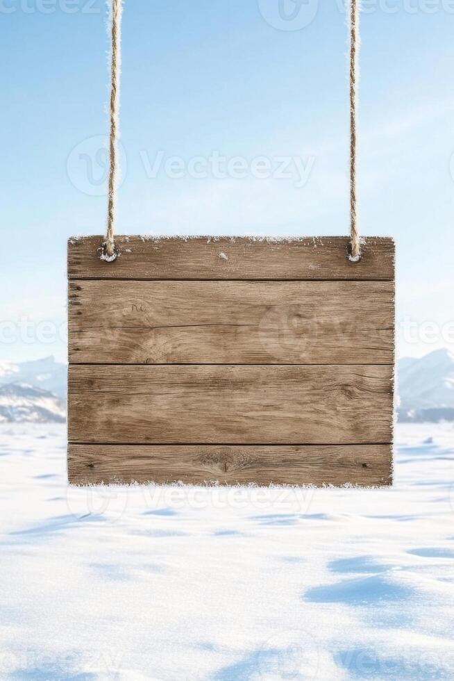 Frosted wooden sign floating gently above the serene winter landscape with icy ground and distant mountains photo