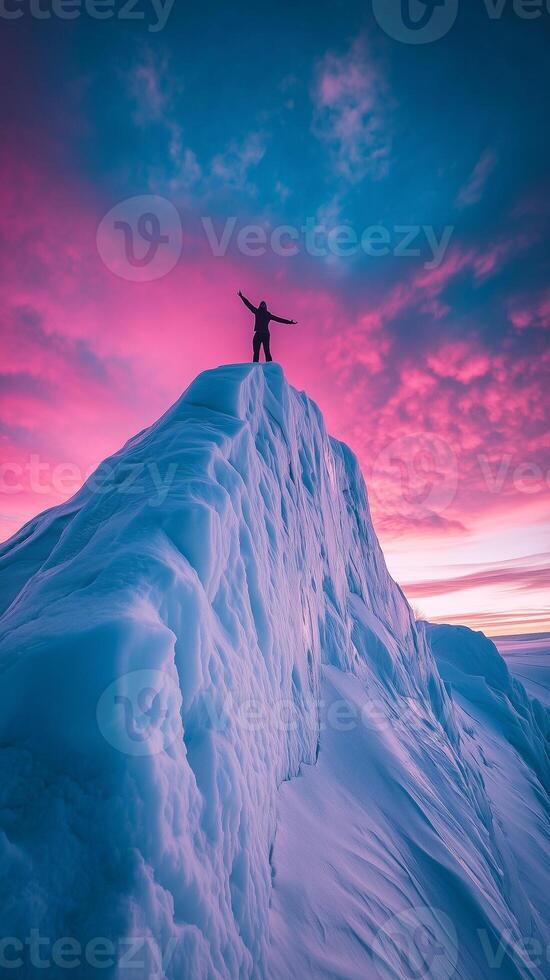 Reaching the Summit A Moment of Triumph Under a Fiery Sky. Man Enjoying View From the Top of a Snowy Mountain. photo