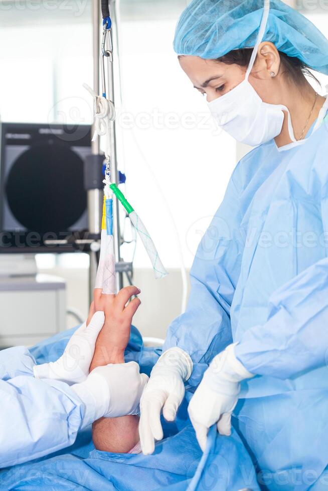 Arm of a patient ready for orthopedic surgery. Female doctor performing surgery. Orthopedic surgeon. Surgery and insurance concept photo