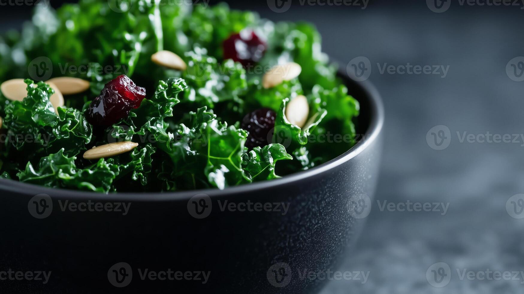 A bowl of kale salad with cranberries and almonds photo