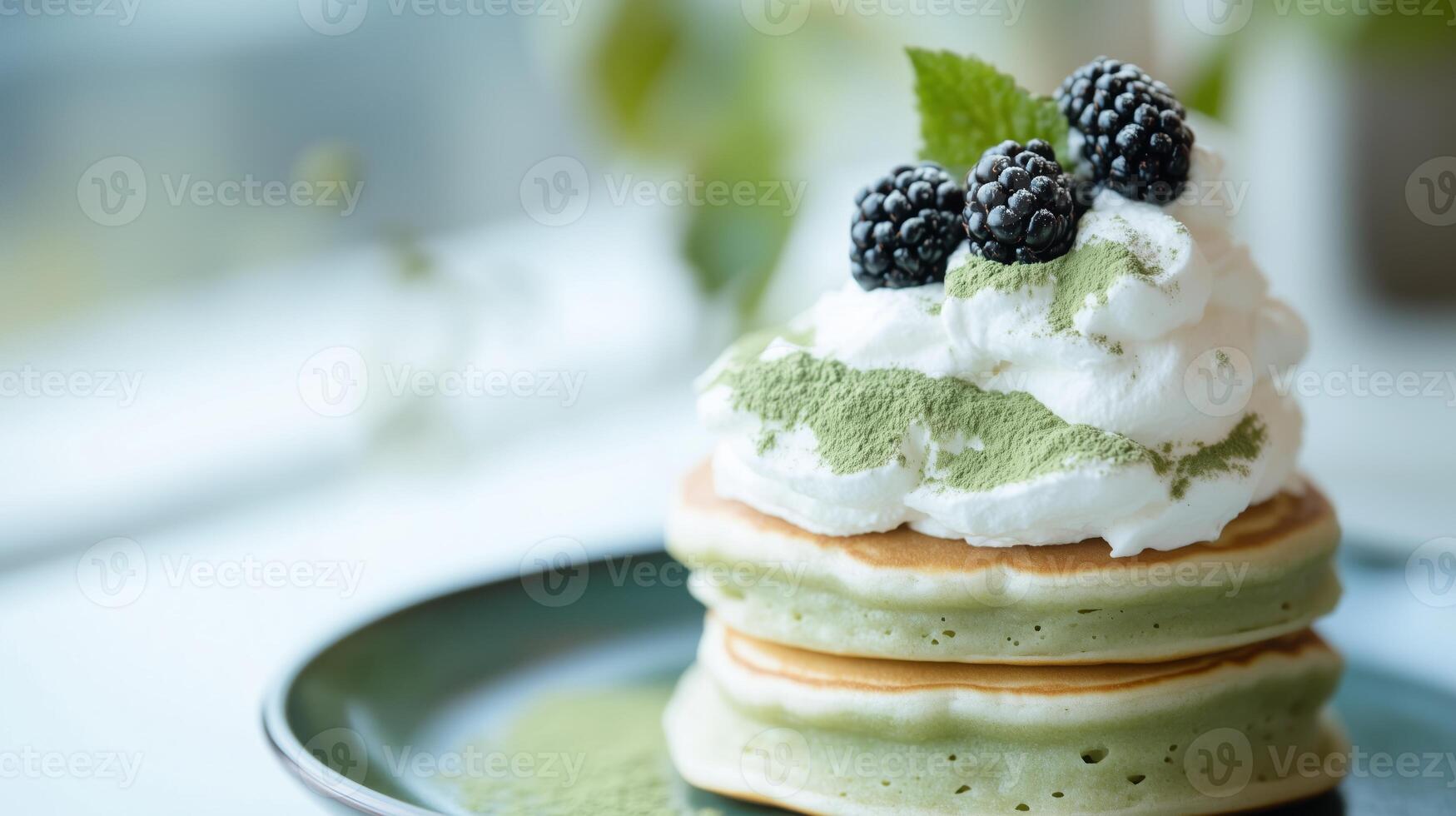 A stack of pancakes topped with whipped cream and blackberries photo