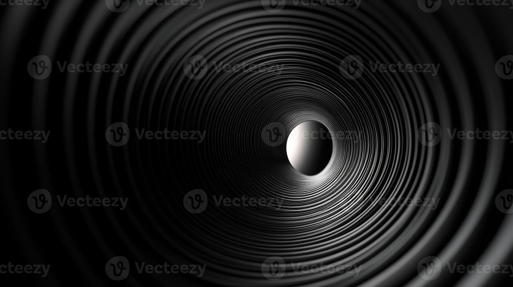 Abstract black spiral tunnel with concentric rings and central light source creating an intriguing optical illusion in monochrome design photo
