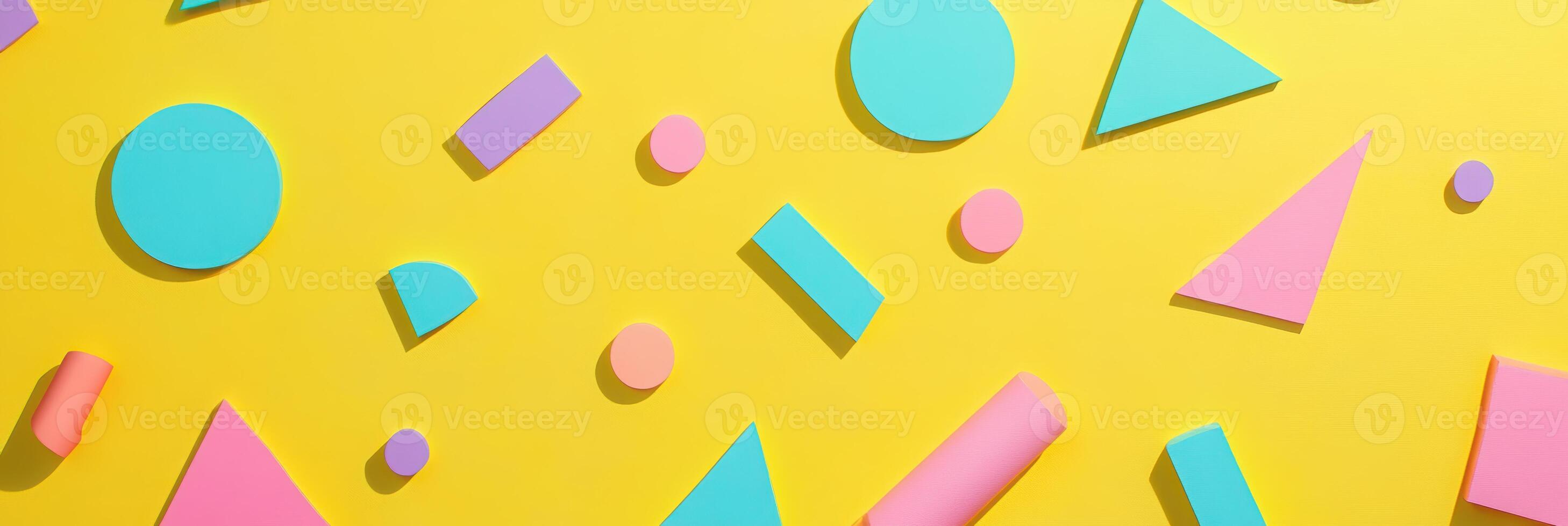 Colorful geometric shapes pattern on vibrant yellow background with circles, triangles, rectangles, and squares in pink, blue, and purple photo
