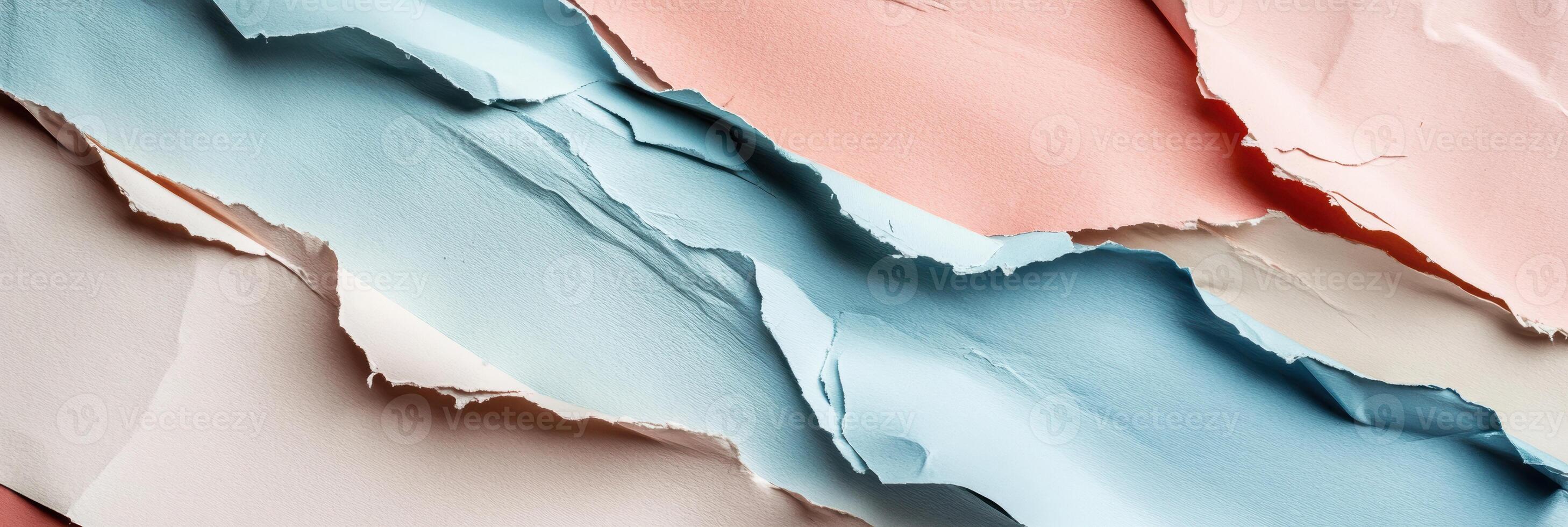 Abstract layers of torn colored paper creating a dynamic texture with pastel blue, pink, and beige hues in a playful artistic pattern photo