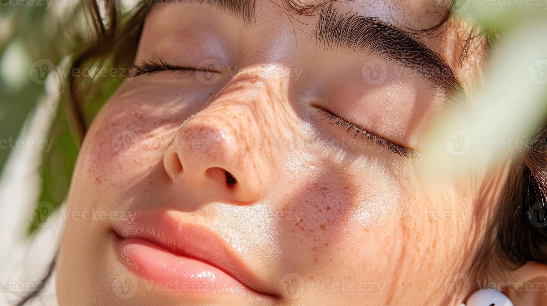 Peaceful moment in nature, young caucasian female enjoys warm sunlight with eyes closed, surrounded by greenery and gentle shadows photo