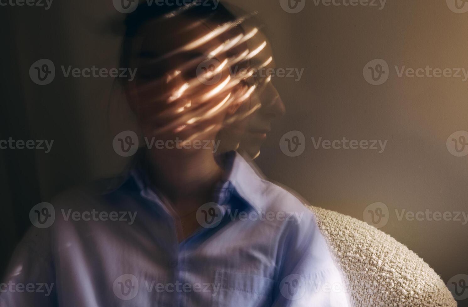 Close-up portrait of a young woman in casual clothes taken at long exposure photo