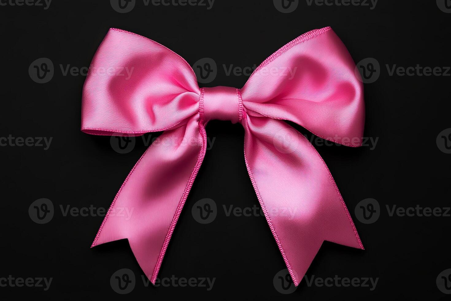 Pink satin bow with elegant loops and tails, beautifully arranged on a dark background, showcasing its smooth texture and vibrant color for decorative purposes photo