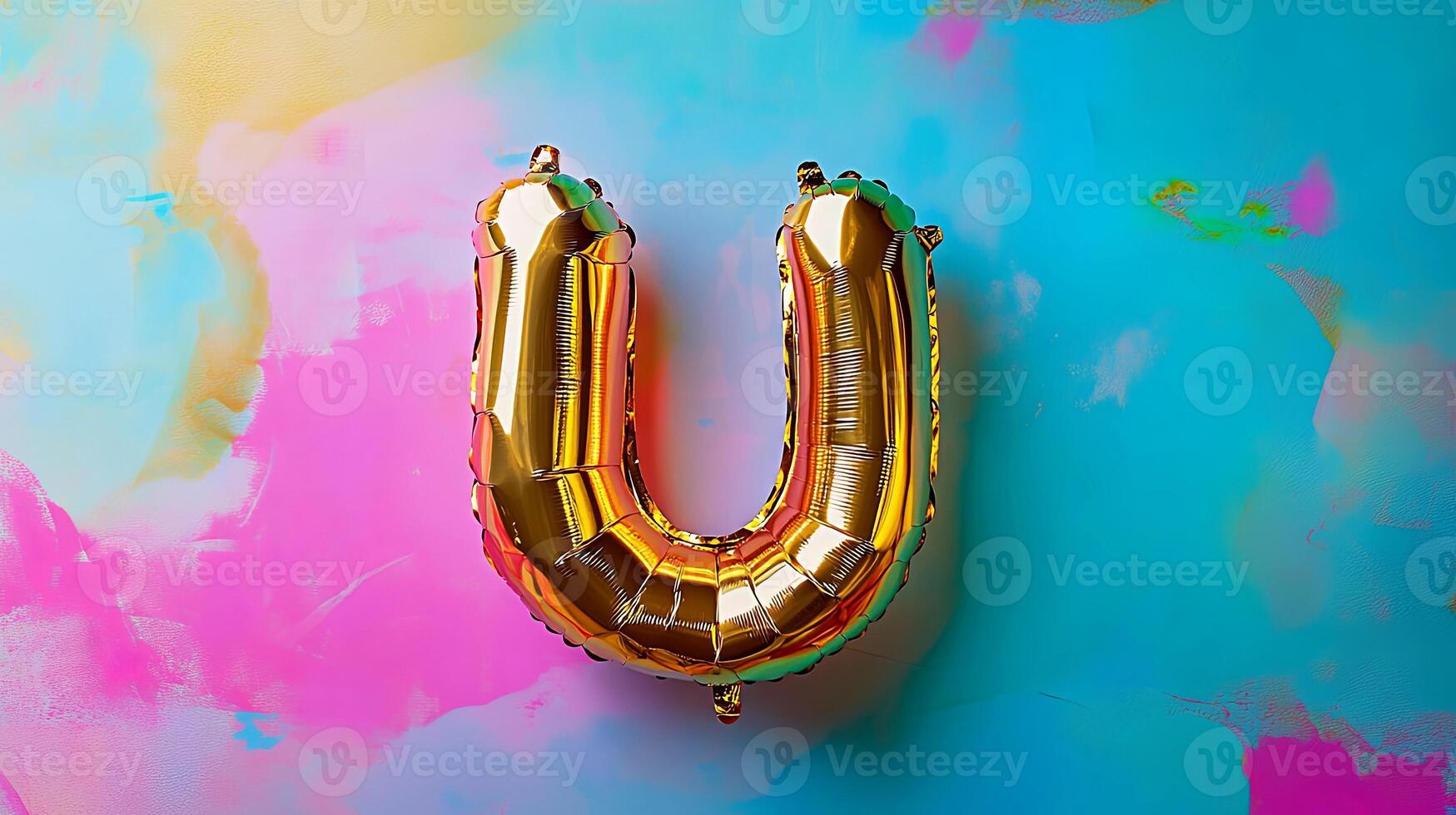 Golden letter U balloon on a vibrant abstract background featuring colorful splashes and textures, creating a festive and playful atmosphere for celebrations and events photo
