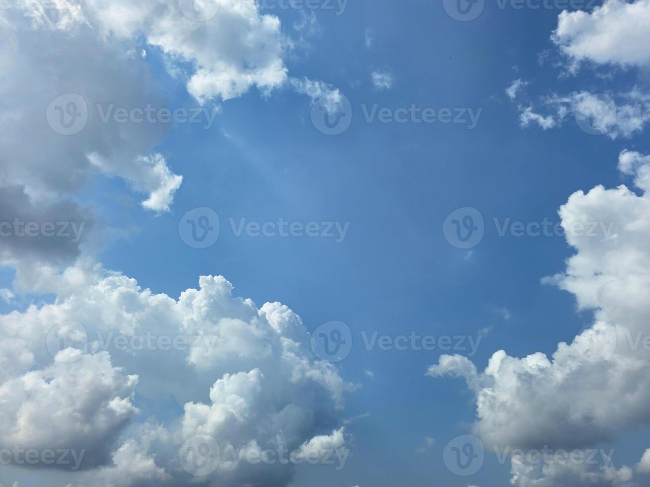 Summer blue sky cloud gradient light white background. Beauty clear cloudy sky. Sun shining through the puffy clouds. Beautiful sunny dynamic sky. Background with clouds on blue. photo