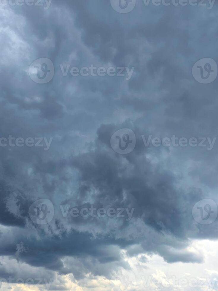 Dramatic Storm sky with dark blue and grey cumulus. Rainy clouds background texture. Just before the heavy rain or thunderstorm. dramatic dark clouds in the sky. Beautiful landscape with cloud photo