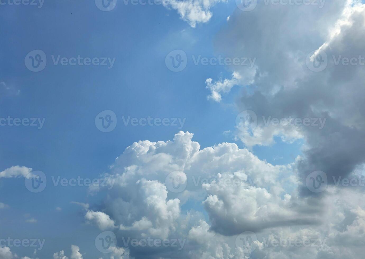 Summer blue sky cloud gradient light white background. Beauty clear cloudy sky. Sun shining through the puffy clouds. Beautiful sunny dynamic sky. Background with clouds on blue. Art of clouds photo
