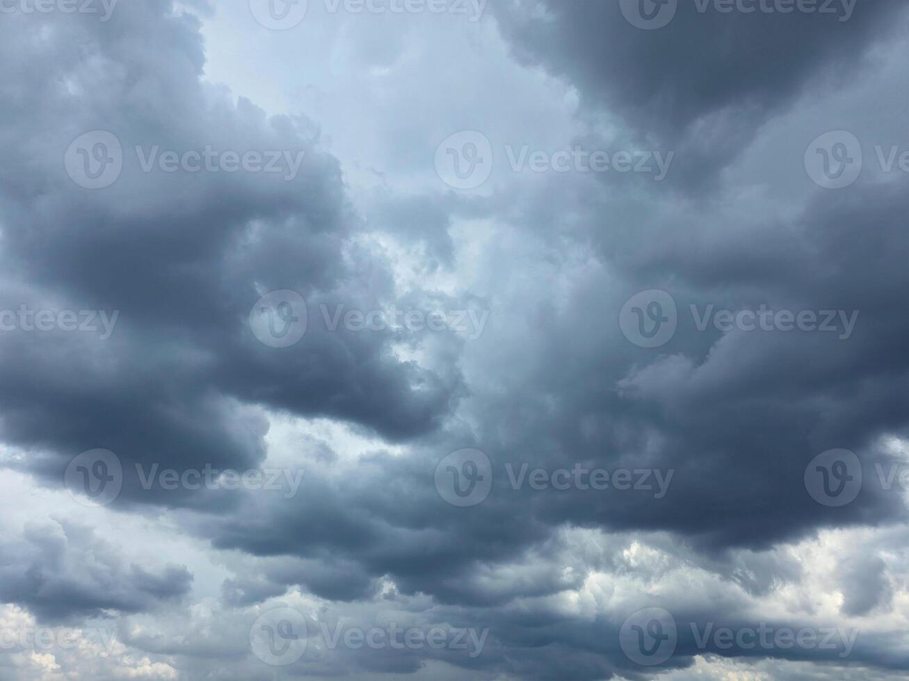 Dramatic Storm sky with dark blue and grey cumulus. Rainy clouds background texture. Just before the heavy rain or thunderstorm. dramatic dark clouds in the sky. Beautiful landscape with cloudy sky. photo