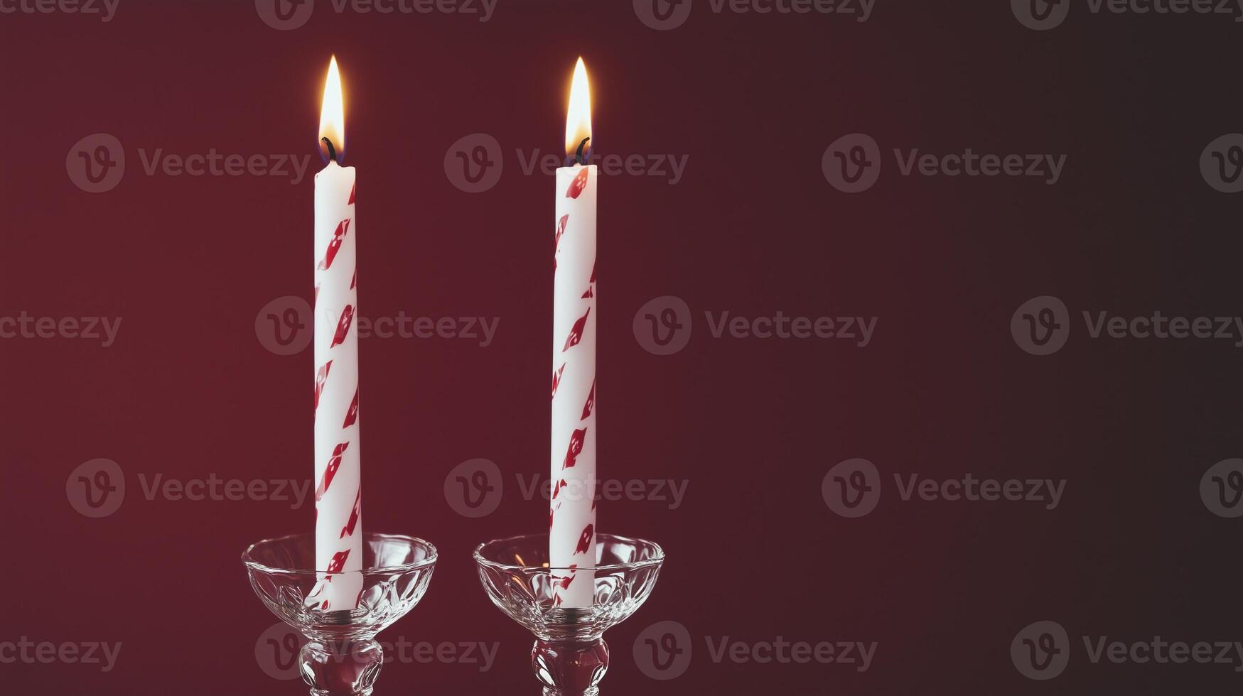 Two candles with white and red stripes on them photo