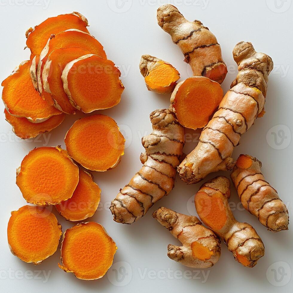 Fresh Turmeric Root Slices and Whole Pieces Displayed photo
