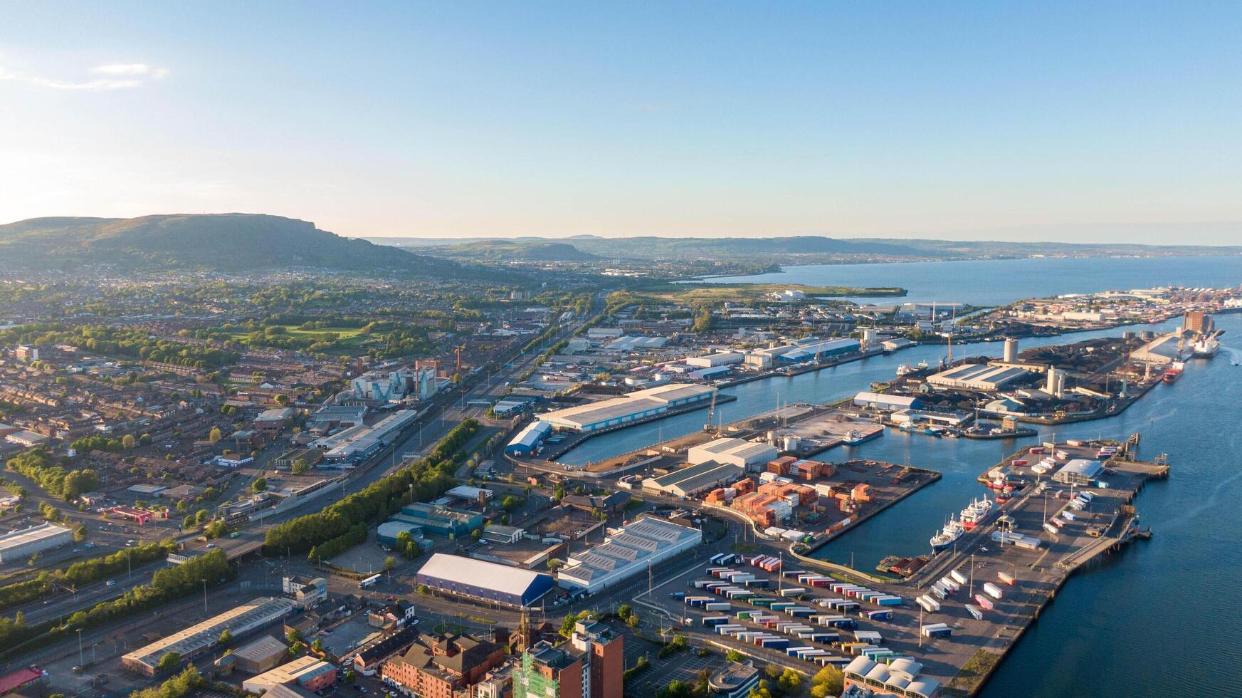 4.5.25 Belfast, UK Aerial view on Lagan River and buildings in City centre of Belfast Northern Ireland. Drone photo, high view of town. Harland and Wolff Shipyard and Docks. photo