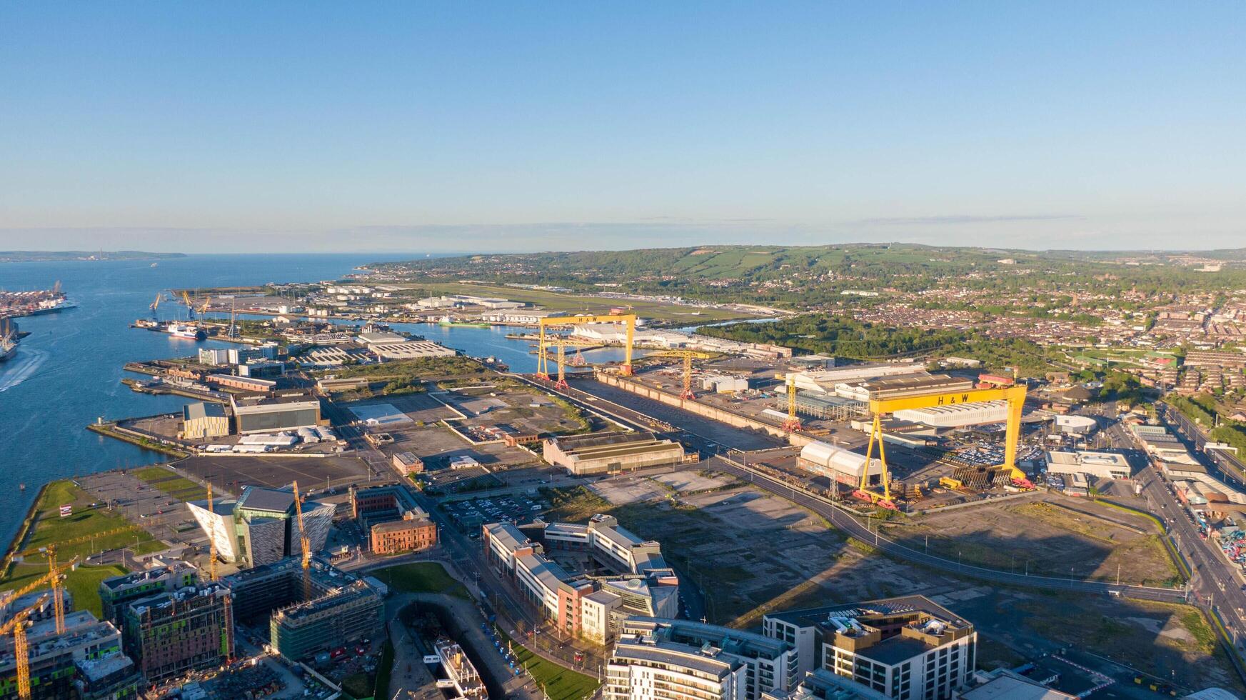4.5.25 Belfast, UK Aerial view on Lagan River and buildings in City centre of Belfast Northern Ireland. Drone photo, high angle view of town. Harland and Wolff Shipyard and Docks photo