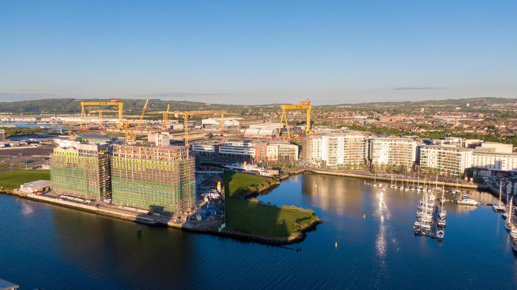 4.5.25 Belfast, UK Aerial view on Lagan River and buildings in City centre of Belfast Northern Ireland. Drone photo, high angle view of town Harland and Wolff Shipyard and Docks. photo