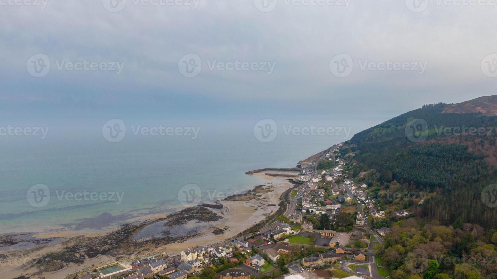 Aerial view of coast of Irish Sea and Mourne Mountains in Newcastle, Northern Ireland. Drone photo of Coastal City