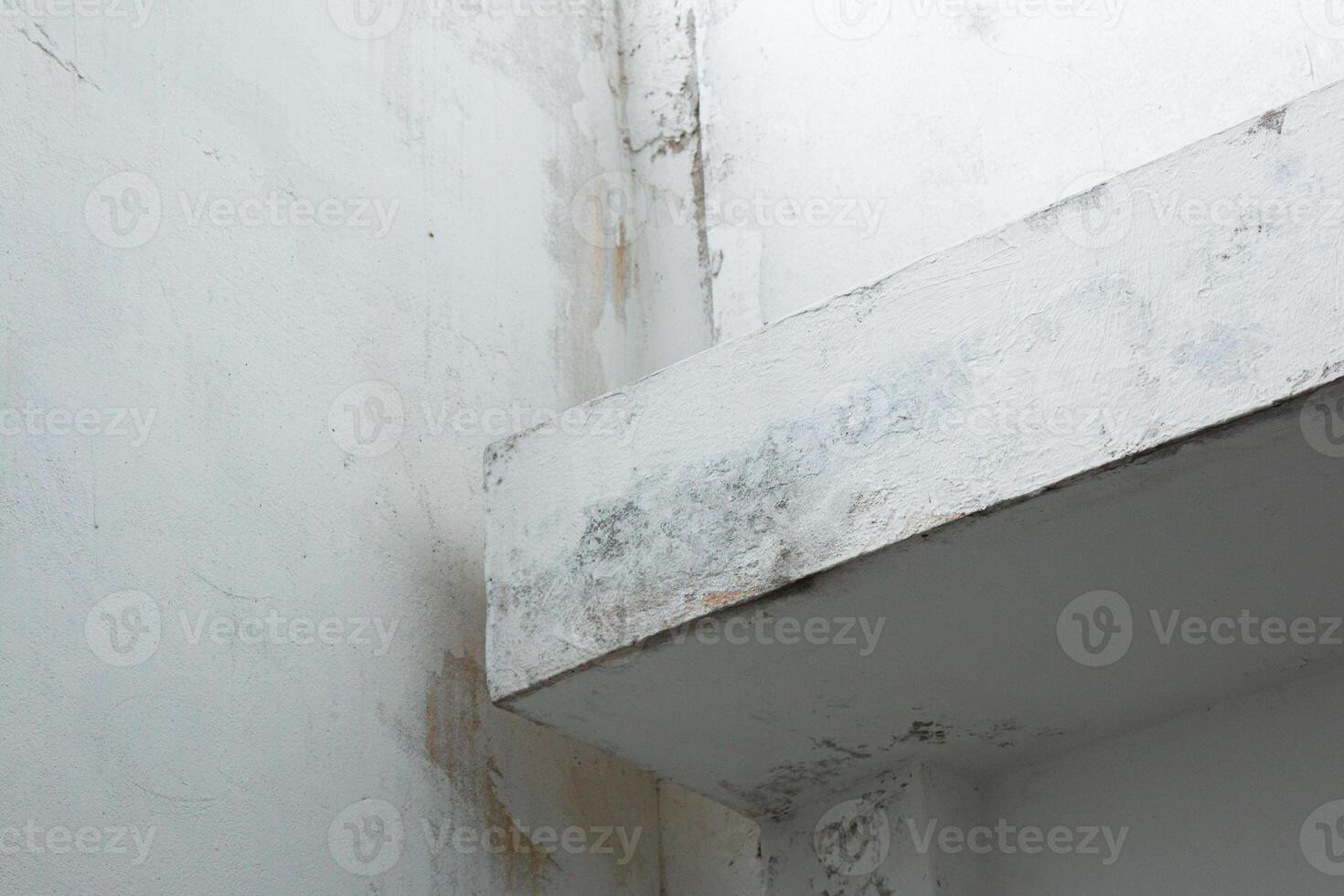 Moldy and stained concrete wall corner photo