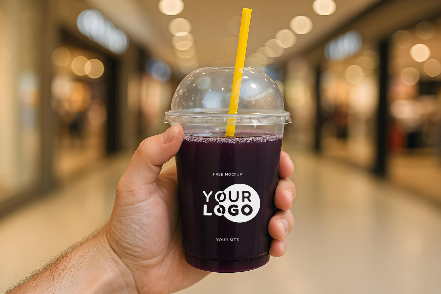 Mockup of a glass of grape juice in a man's hand at the mall psd