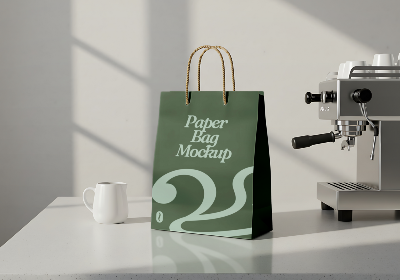 A green paper bag mockup sits on a table next to a coffee machine and a small creamer psd
