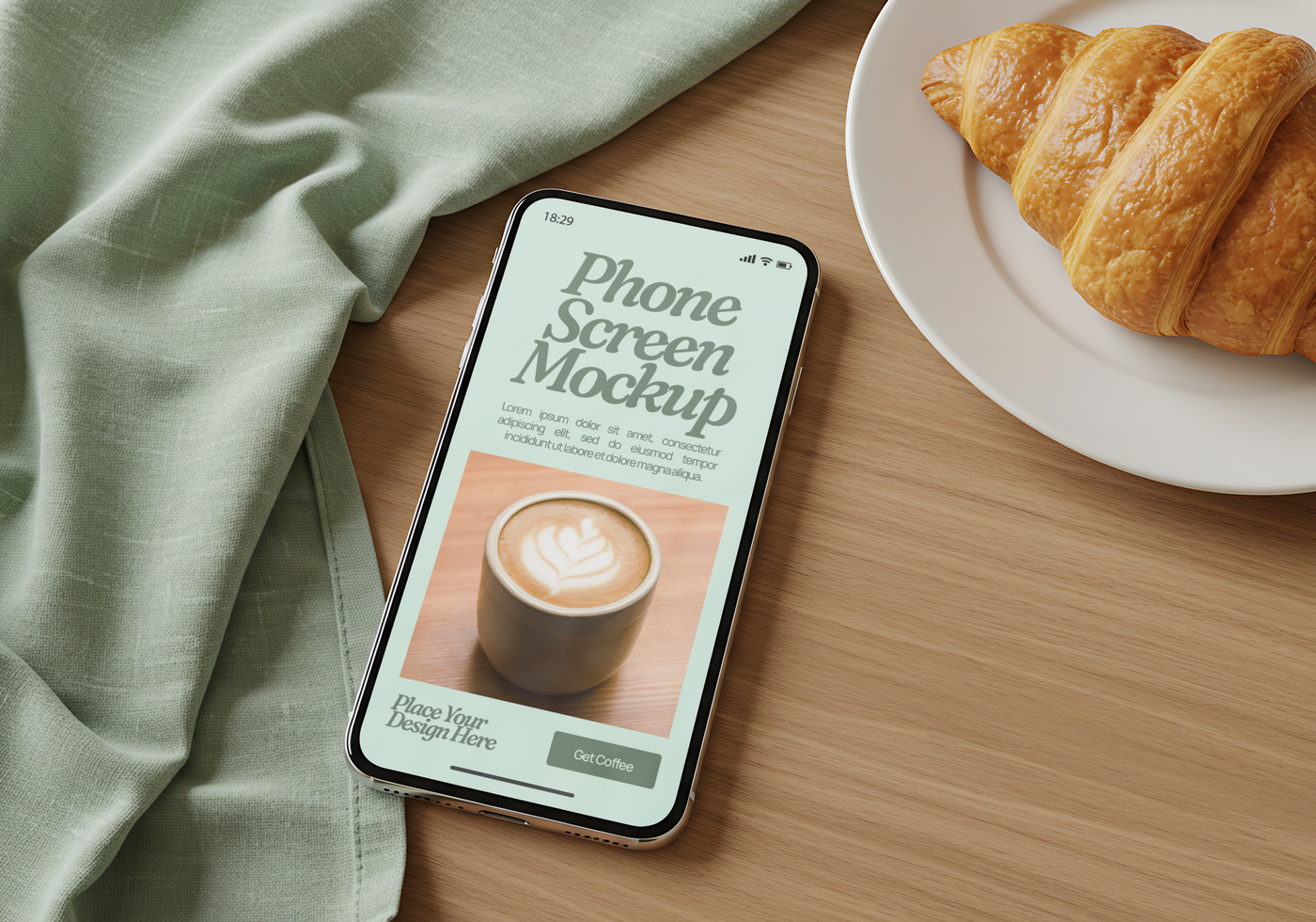 A phone screen mockup displays a latte art design alongside a croissant and a sage colored cloth psd