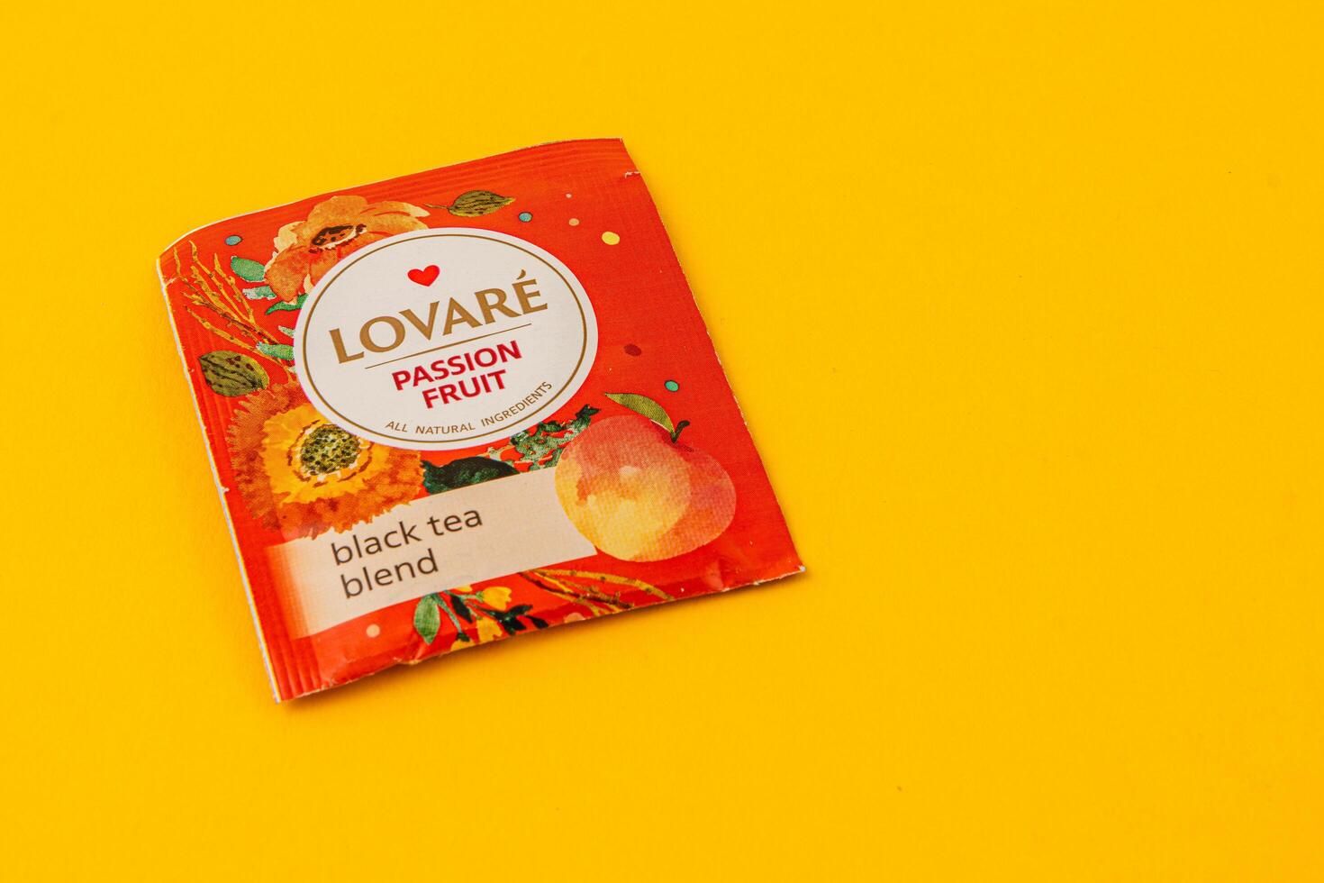Lviv Ukraine 05.06.25 Passion fruit black tea blend on vibrant yellow background photo