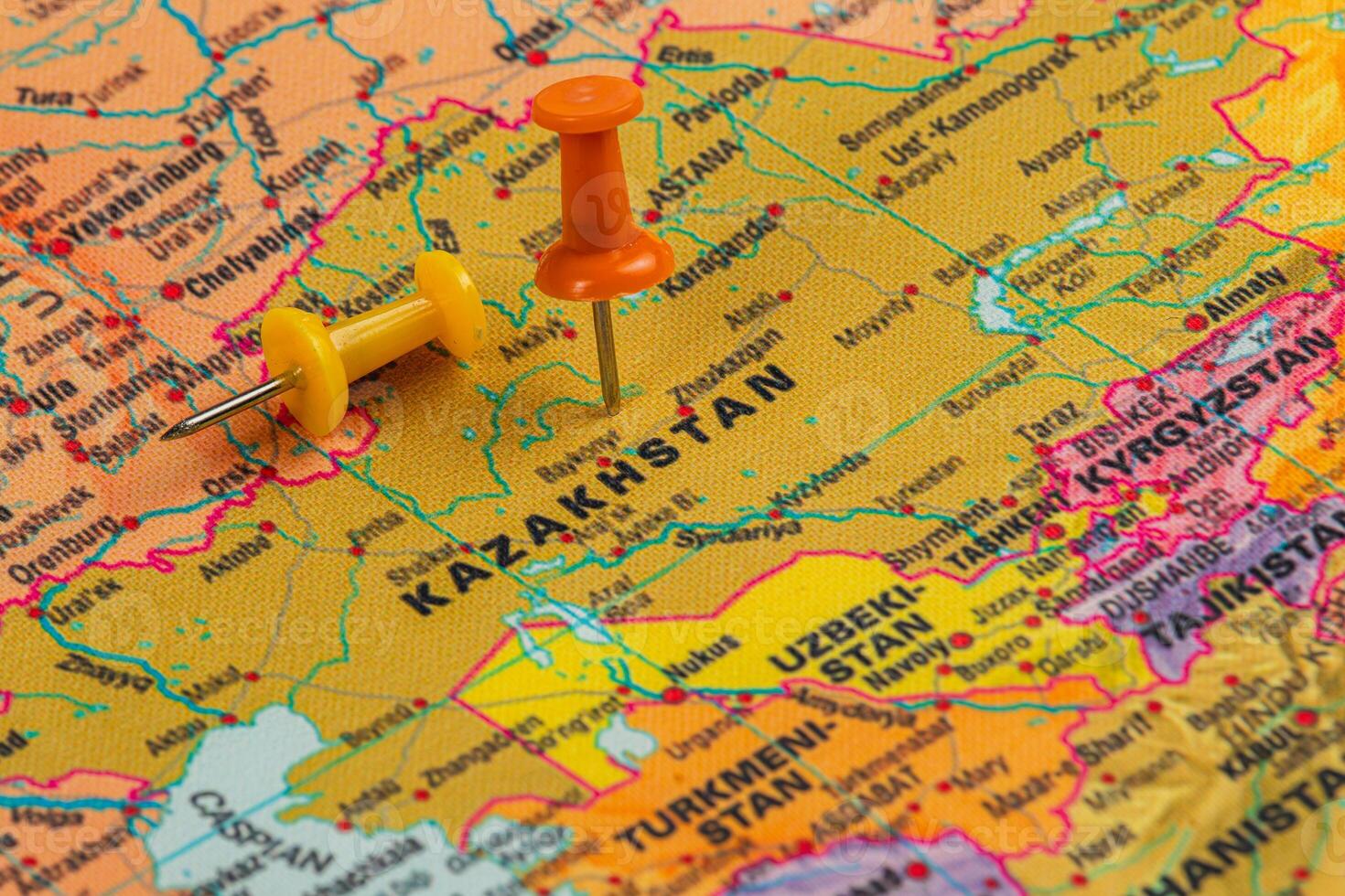 Map highlighting Kazakhstan with colorful push pins attached photo