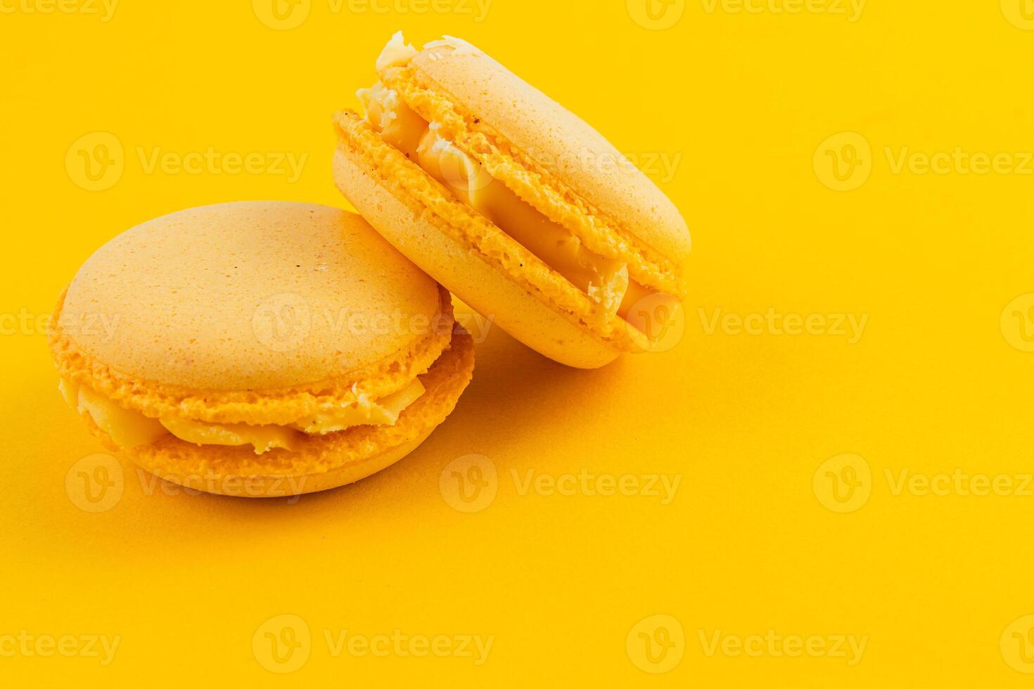 Bright yellow macarons on a vibrant background photo