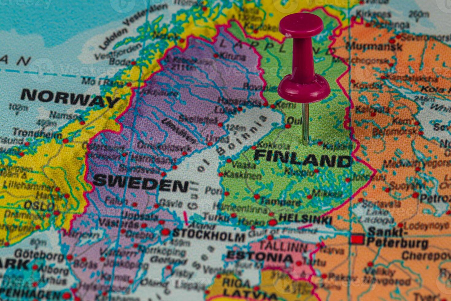 Finland marked on a map with a pushpin in focus photo