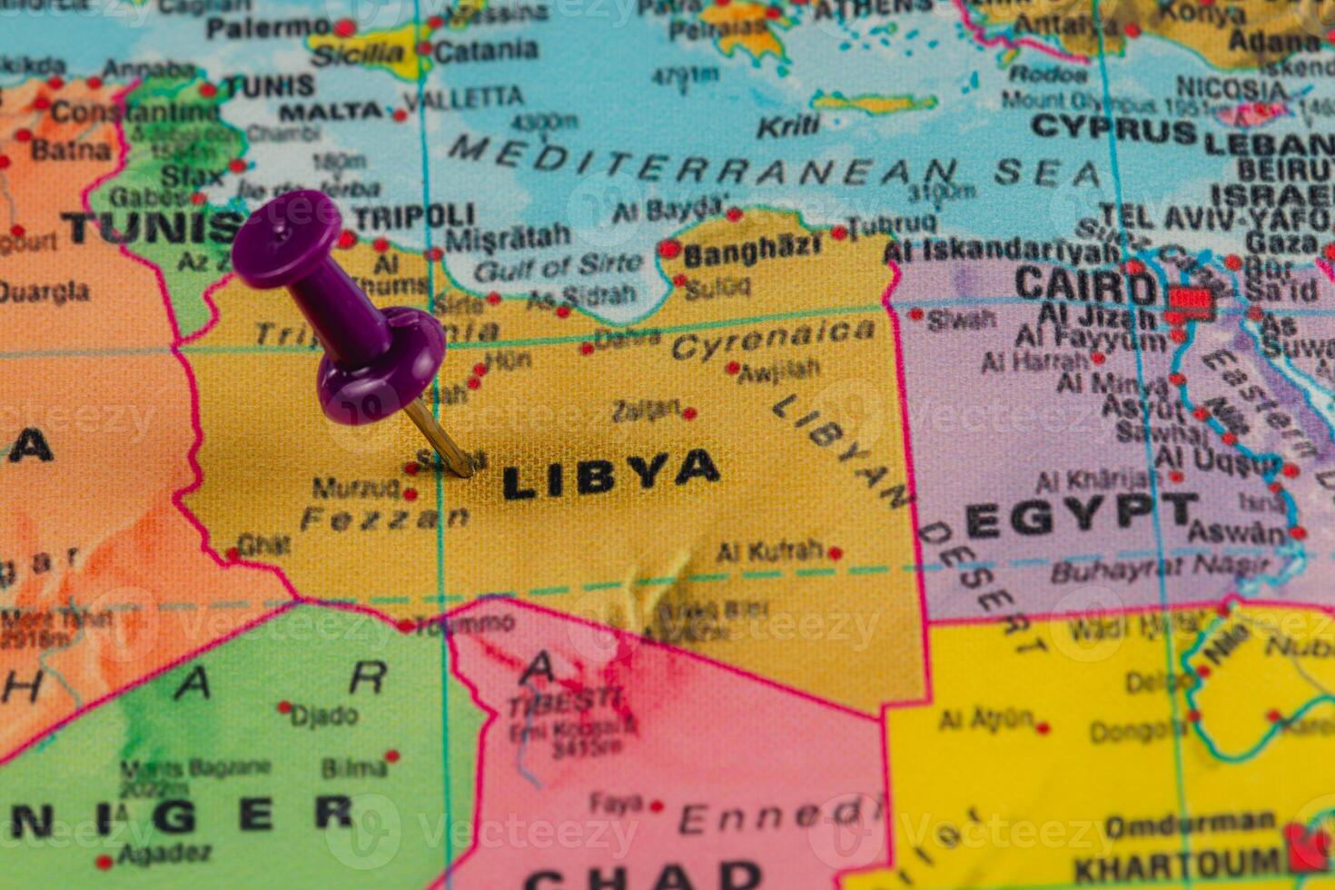 Pinpointing Libya on a detailed world map close-up photo