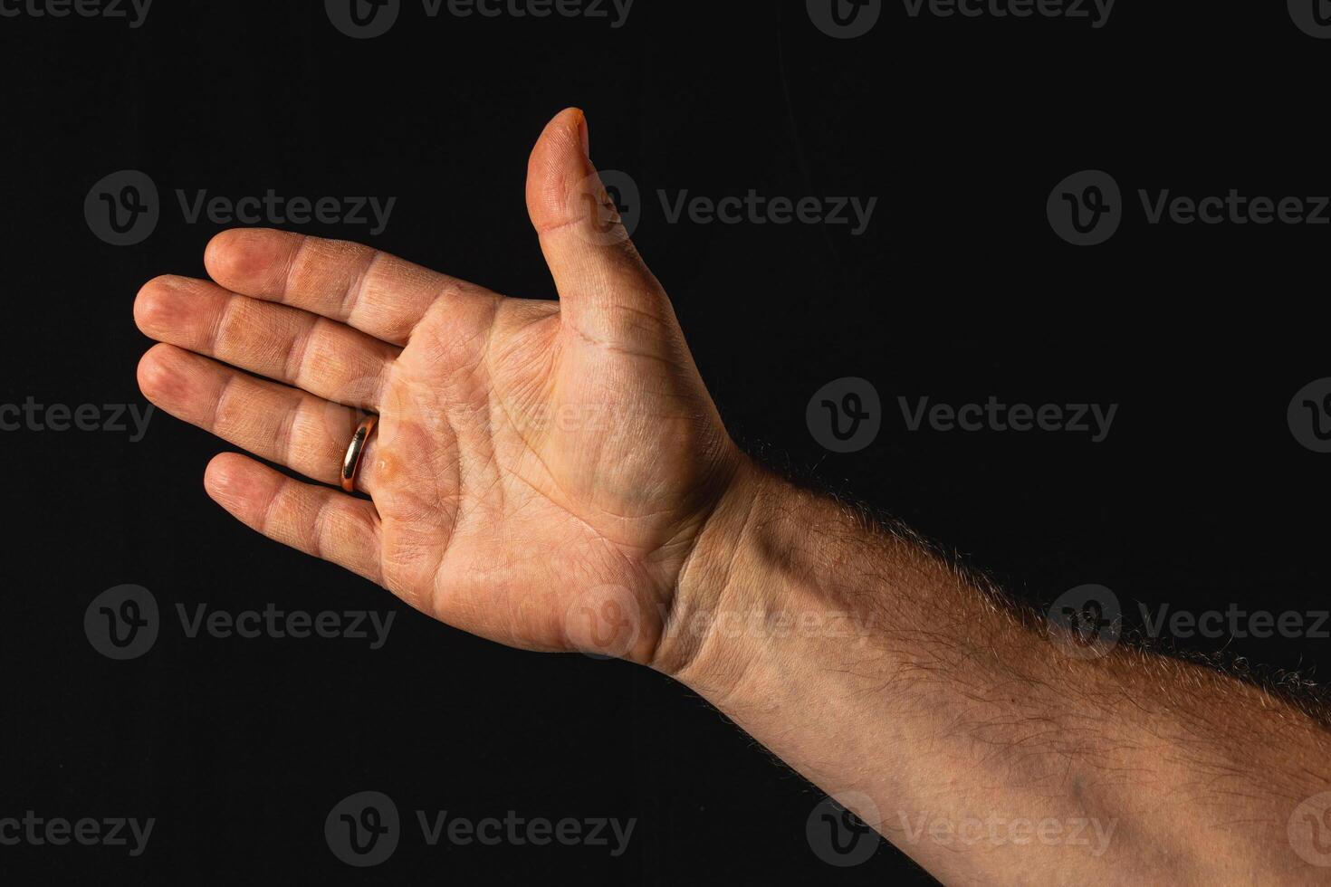 Hand gesture expressing openness on a dark background photo