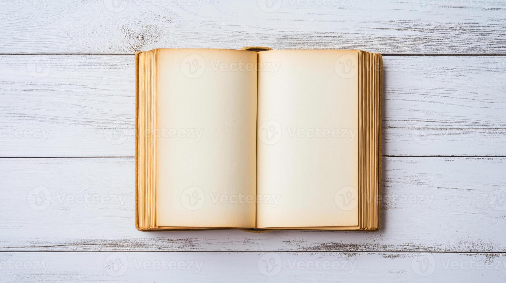 open old book or magazine lying on a white wooden surface. The book appears to be blank, with no text or images on the pages photo