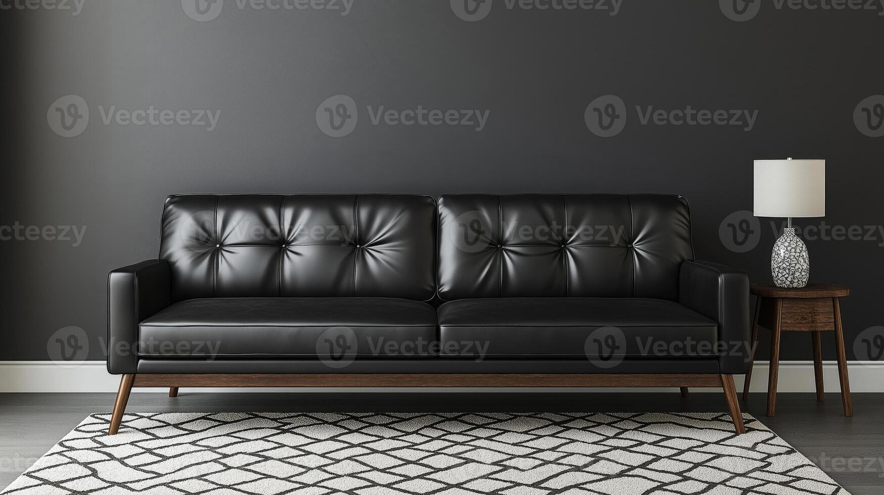 modern living room with a black leather sofa against a dark grey wall. The sofa is placed against the wall with a geometric patterned rug in front of it. photo