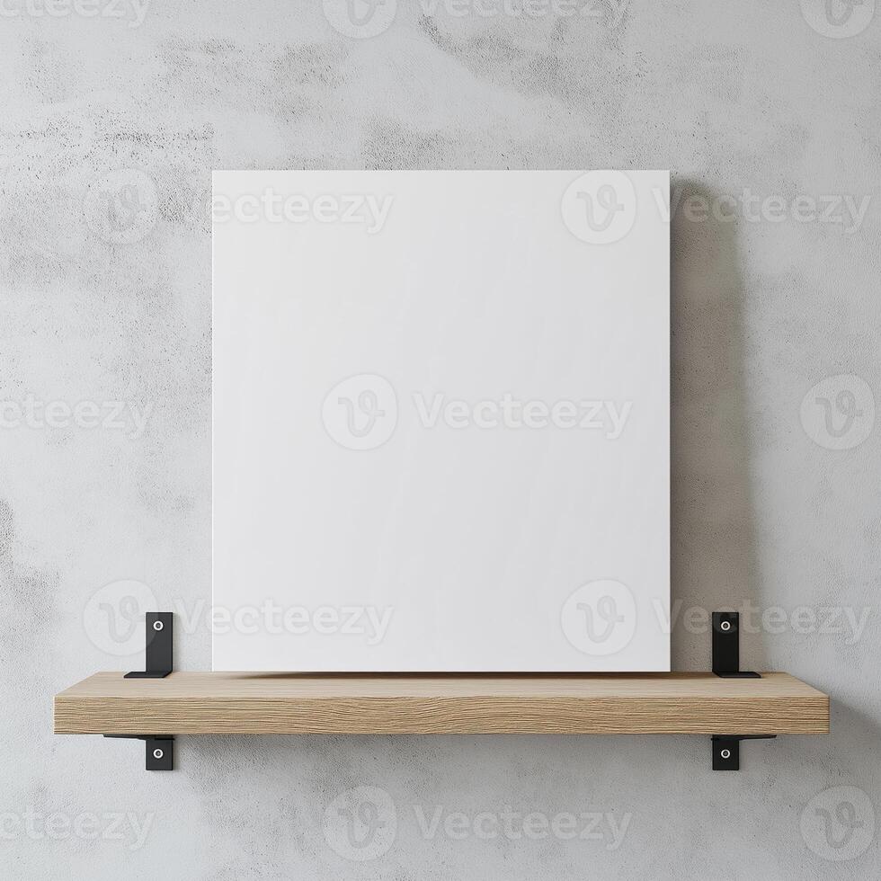 blank white canvas hanging on a wooden shelf against a gray concrete wall. The canvas is rectangular in shape and appears to be made of a light-colored wood. photo