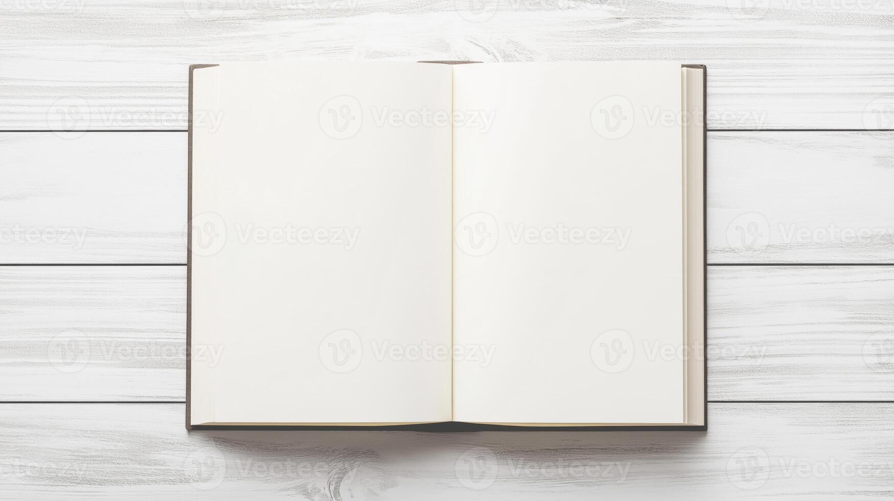 open plain white book or magazine lying on a white wooden surface. The book appears to be blank, with no text or images on the pages photo