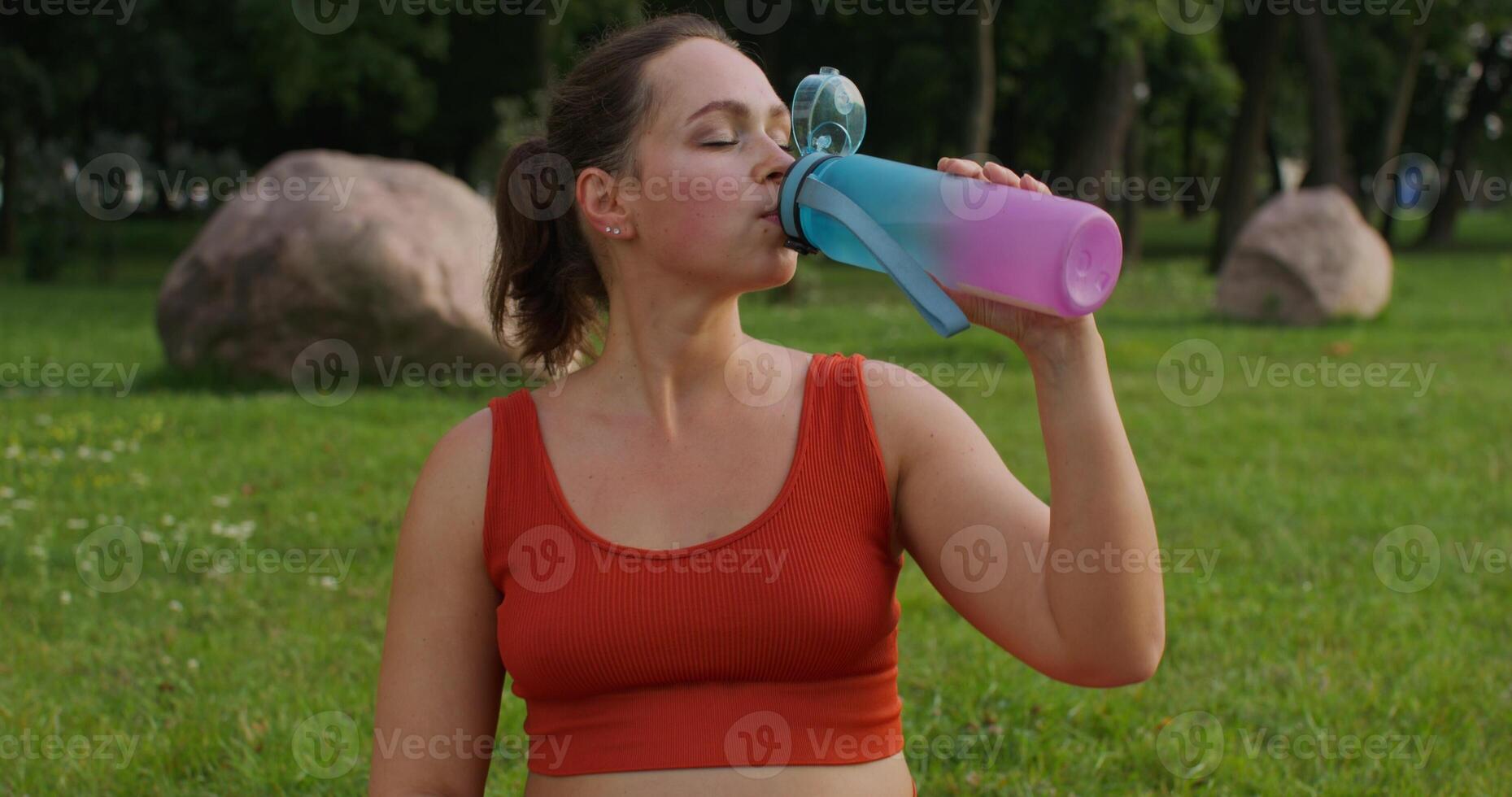 Woman drinking water after exercise photo