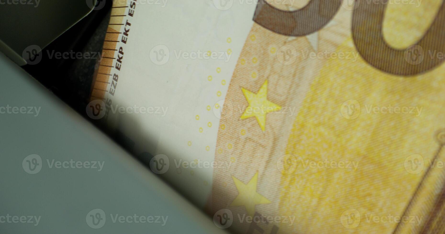 Euro banknotes in the counting machine. The currency of the European Union. Close-up photo
