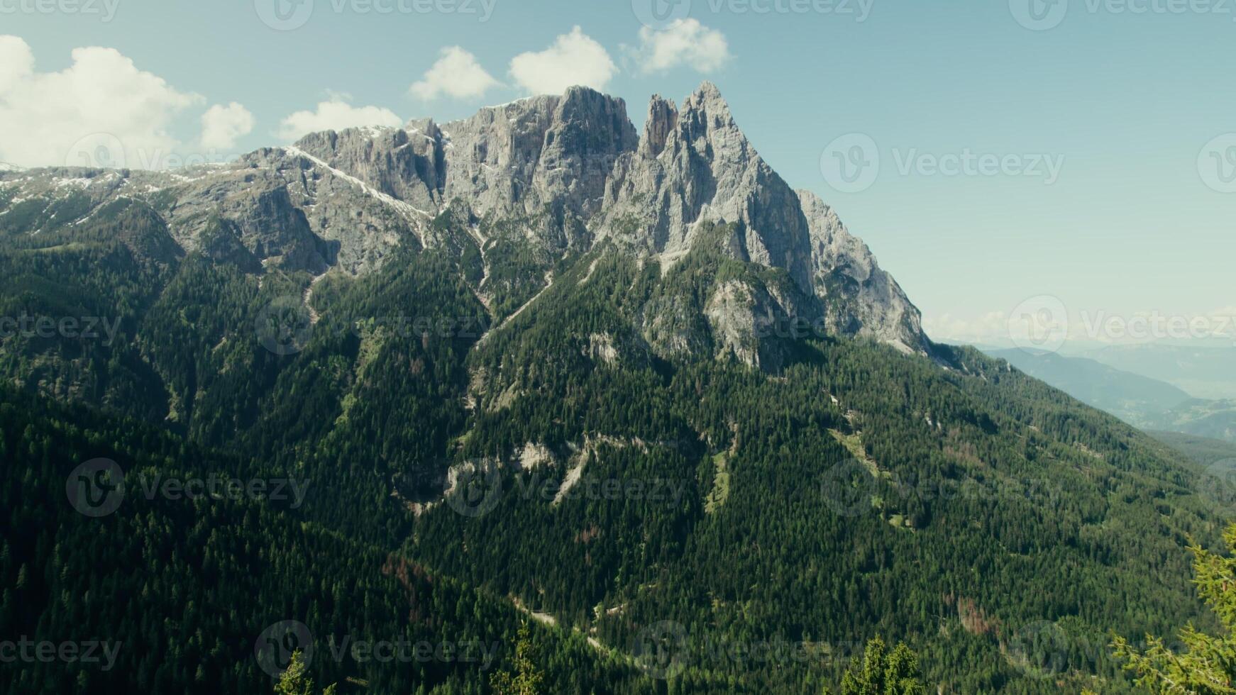 Drone view of a high-altitude valley with rocky peaks and slopes overgrown with spruce forest - overgrown photo