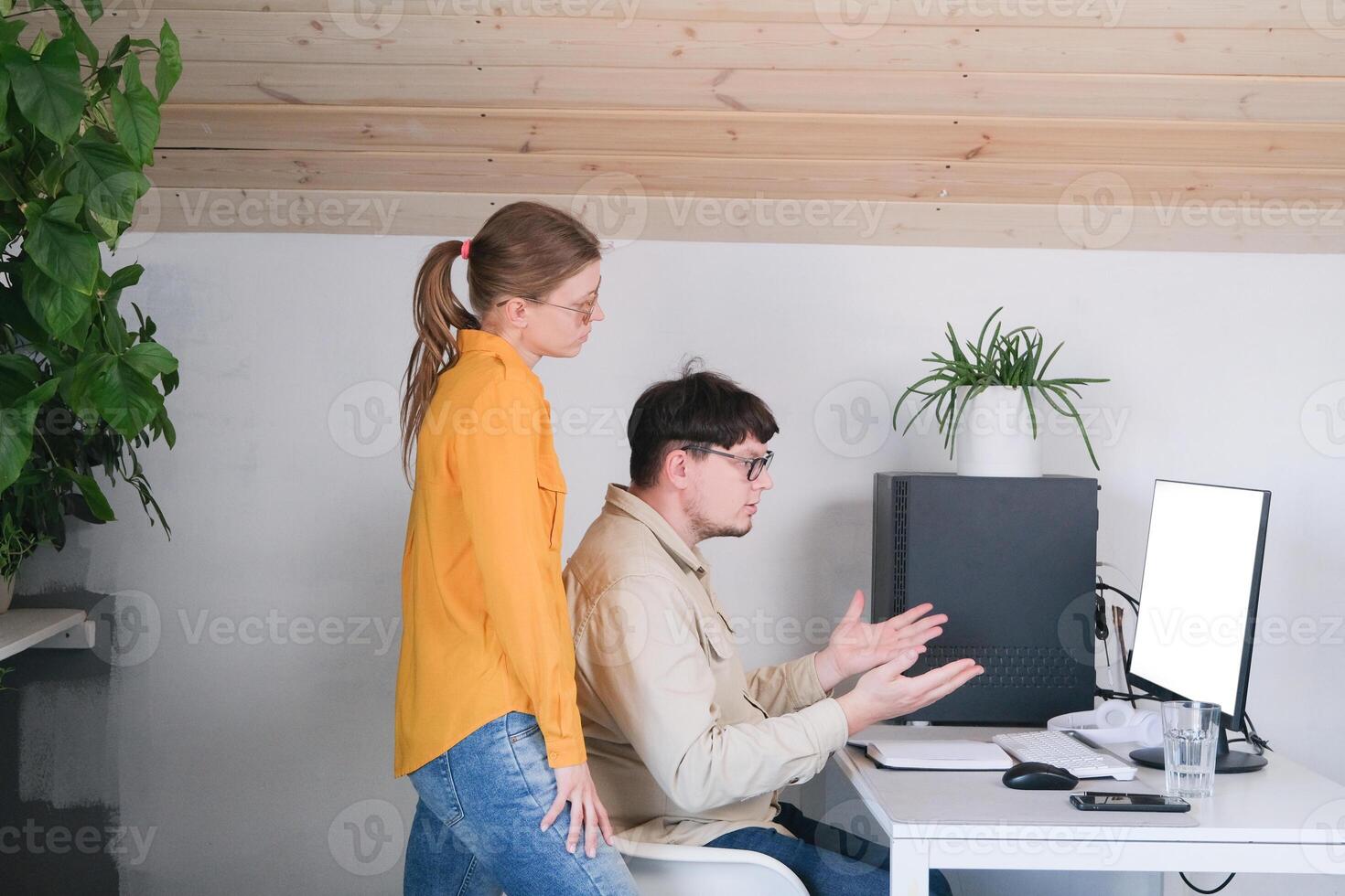 millennial man and woman in casual clothes using and computer while spending time at home photo