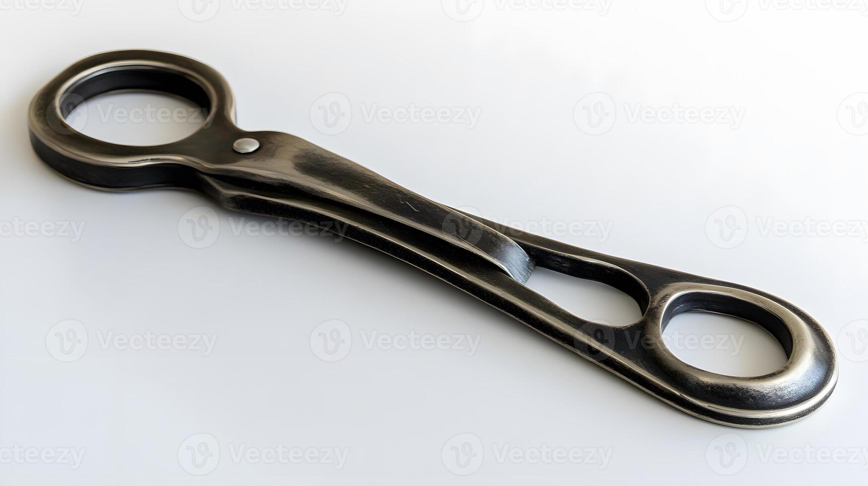 A wrench with a handle on a white surface photo