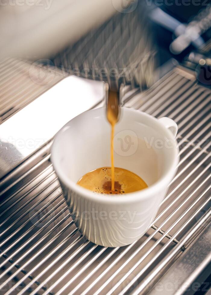 Professional coffee machine pouring espresso coffee photo