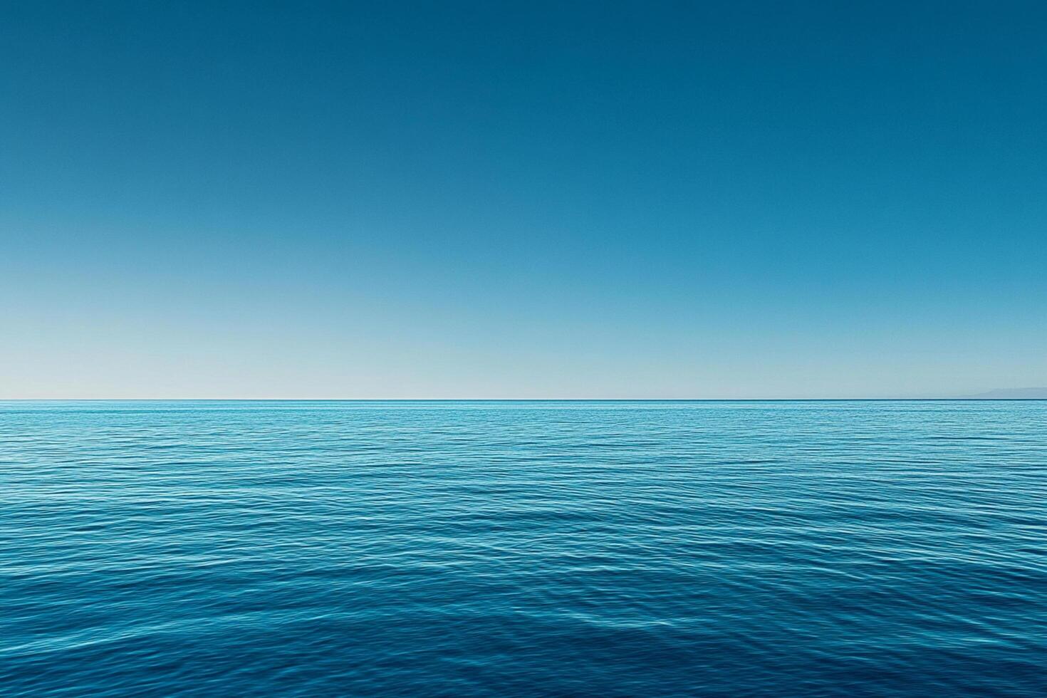 Calm turquoise waters reflect a clear sky during midday in a serene coastal location photo