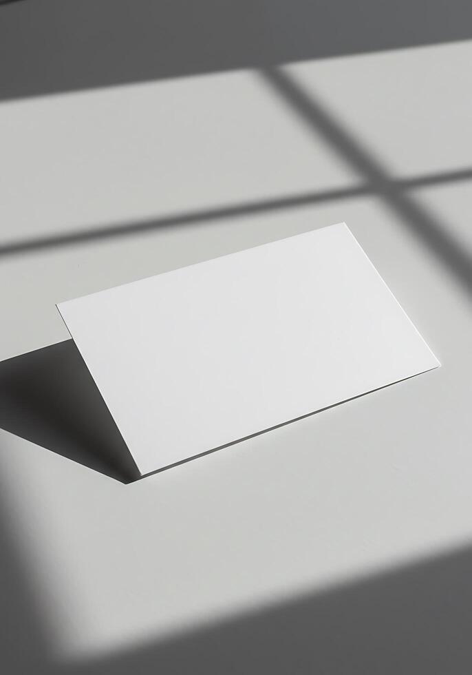 A blank white card is sitting on a table photo