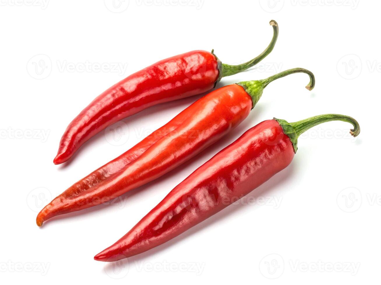 Three vibrant red chili peppers isolated on a white background showcasing their glossy texture and curved stems photo
