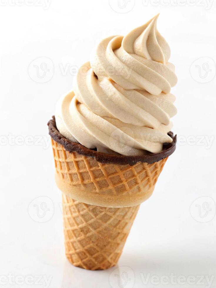 Creamy vanilla soft serve ice cream cone with chocolate rim isolated on white background photo