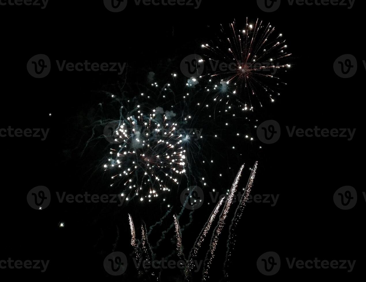 Stunning fireworks display exploding against a dark night sky. photo