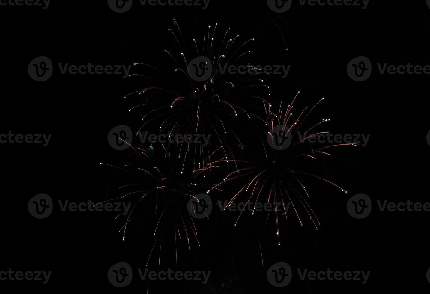 Stunning fireworks display against a pitch-black night sky. photo