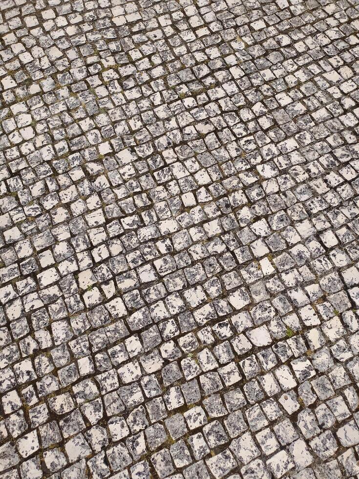Highangle view of a textured cobblestone pavement. Perfect for backgrounds, textures, or illustrating concepts of history, journeys, or urban landscapes. photo